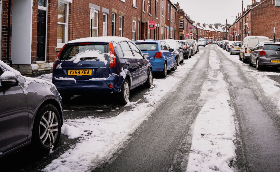 Cars parked on road in Winter snow