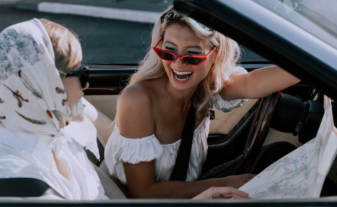 Girls in car laughing about funny and rude number plates